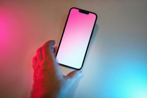 A person holding a cell phone in their hand
